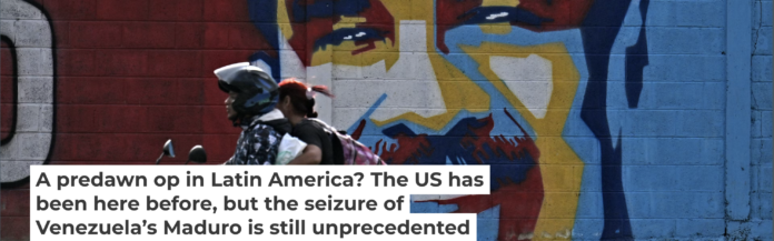 A motorcycle rides past graffiti depicting Venezuelan President Nicolas Maduro in Caracas on Jan. 3, 2026. Juan Barreto/AFP via Getty Images